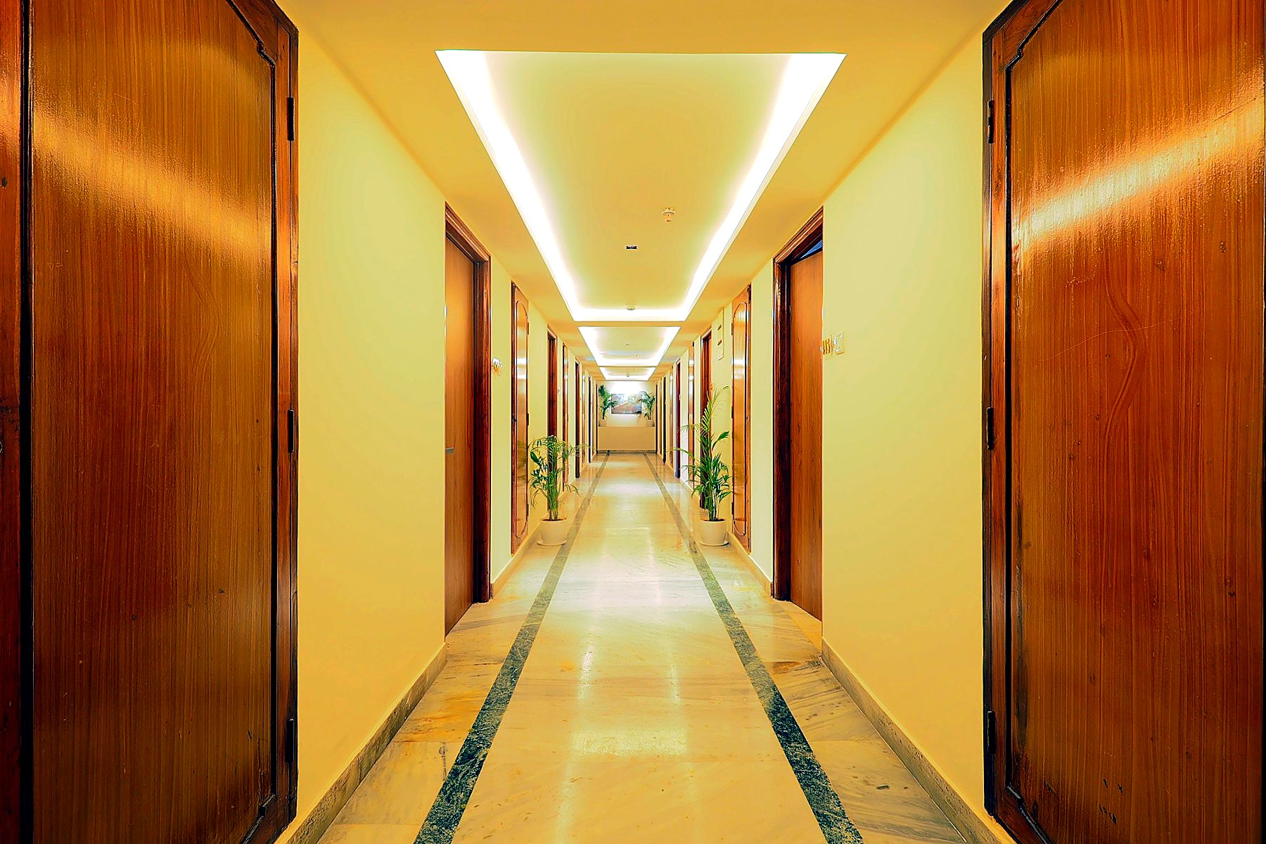 Guest corridor with cove lighting and timber doors